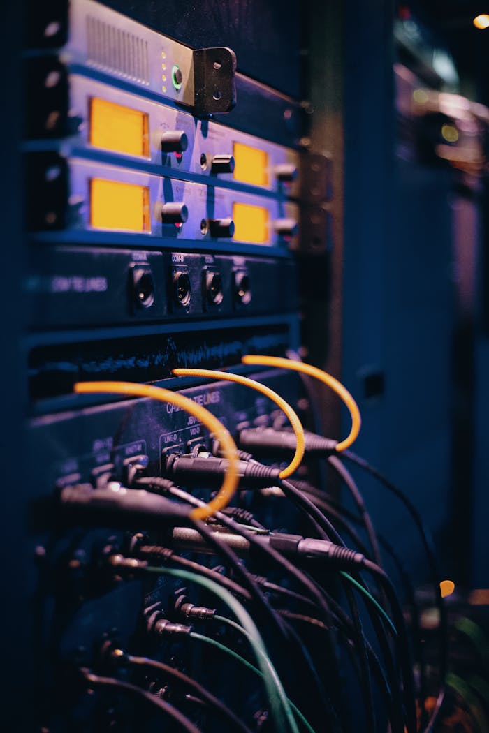 contact-img Close-up of network cables and ports in a server rack, showcasing connectivity.