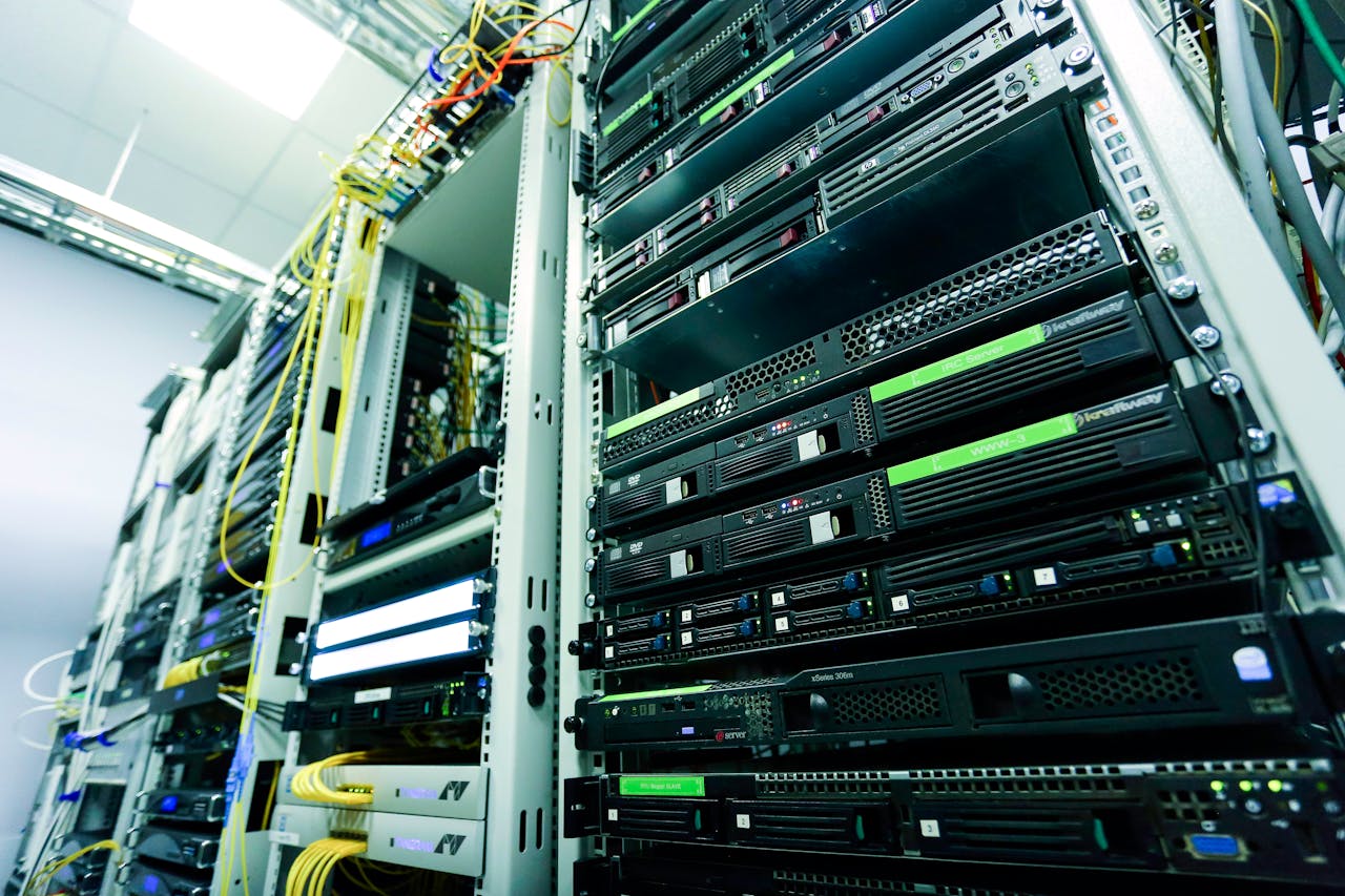 services-img High-tech server rack in a secure data center with network cables and hardware components.